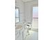 Bathroom sink with white vanity, soft colors and natural light from obscured glass window at 10450 W Sutters Gold Ln, Sun City, AZ 85351