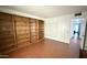 Bedroom with built in shelving and storage with wood laminate flooring at 10450 W Sutters Gold Ln, Sun City, AZ 85351