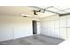 Well-lit garage featuring built-in cabinets for storage, offering a clean and organized space at 10450 W Sutters Gold Ln, Sun City, AZ 85351