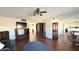 Open living room featuring hardwood floors, a ceiling fan, and an open floor plan at 10450 W Sutters Gold Ln, Sun City, AZ 85351