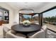 Dining room featuring a circular table with desert views visible through expansive sliding glass doors at 10585 E Crescent Moon Dr # 44, Scottsdale, AZ 85262