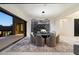 Dining area with large sliding doors, a modern chandelier, and a custom wine display at 10585 E Crescent Moon Dr # 44, Scottsdale, AZ 85262