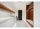 Modern laundry room features sleek white cabinetry and a convenient built-in bench at 10585 E Crescent Moon Dr # 44, Scottsdale, AZ 85262