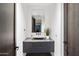 Contemporary powder room featuring a sleek black vanity and a modern mirror at 10585 E Crescent Moon Dr # 44, Scottsdale, AZ 85262