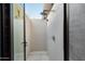 Modern outdoor shower with textured walls, a rain showerhead, and a glass enclosure at 10585 E Crescent Moon Dr # 44, Scottsdale, AZ 85262