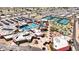 Aerial view of the community recreation center showcasing tennis courts, putting green, pool, and surrounding neighborhood at 10718 W Welk Dr, Sun City, AZ 85373