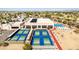 Extensive aerial view showcasing outdoor recreational facilities with a modern recreational center in the background at 10718 W Welk Dr, Sun City, AZ 85373