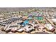 Aerial view of the community recreation center featuring a pool, lazy river, tennis courts, and putting green at 10718 W Welk Dr, Sun City, AZ 85373