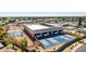 Aerial view of a modern recreation center featuring tennis courts, a running track, and landscaped grounds at 10718 W Welk Dr, Sun City, AZ 85373