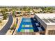 Aerial view of pickleball courts, running track and a modern recreation center in a residential community at 10718 W Welk Dr, Sun City, AZ 85373