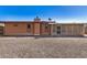 Backyard featuring gravel landscaping, a block fence and a covered patio, low maintenance and functional at 10718 W Welk Dr, Sun City, AZ 85373