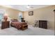 Bedroom features carpet, neutral walls and vintage furniture at 10718 W Welk Dr, Sun City, AZ 85373