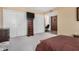 Bedroom with carpet flooring and neutral walls features a dresser with a tv at 10718 W Welk Dr, Sun City, AZ 85373