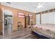 Bedroom with wood flooring features a bookshelf and access to backyard at 10718 W Welk Dr, Sun City, AZ 85373