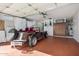 Well-organized garage featuring built-in cabinets, a pegboard, and a classic car at 10718 W Welk Dr, Sun City, AZ 85373