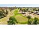 Aerial view of the green golf course showcasing the putting green, and the sand trap at 10718 W Welk Dr, Sun City, AZ 85373