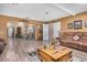 Inviting living room featuring wood-look flooring, neutral walls and a comfortable seating area at 10718 W Welk Dr, Sun City, AZ 85373