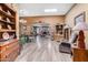 Spacious living room featuring skylights, a dining area and a charming brick fireplace at 10718 W Welk Dr, Sun City, AZ 85373