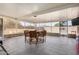 Enclosed patio with tile floor, a ceiling fan, and dining table set, perfect for outdoor entertaining at 10718 W Welk Dr, Sun City, AZ 85373