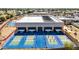 Overhead shot of pickleball courts with blue surfaces, complete with nets and players in action at 10718 W Welk Dr, Sun City, AZ 85373