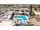 Aerial shot showcasing a community pool with lounge chairs, a hot tub, and a splash pad for  at 10718 W Welk Dr, Sun City, AZ 85373