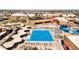 Aerial view of a large swimming pool complex including a lap pool, a recreation pool, and many shaded seating areas at 10718 W Welk Dr, Sun City, AZ 85373