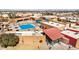 Aerial view of a large swimming pool complex including a lap pool, and many people enjoying their time at 10718 W Welk Dr, Sun City, AZ 85373