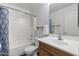 Well-lit bathroom features a shower-tub combination, a white toilet, and a wood vanity at 1113 E Devon Dr, Gilbert, AZ 85296