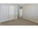 A simple bedroom shot with sliding door closet and light carpet at 1113 E Devon Dr, Gilbert, AZ 85296