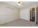 This is a bedroom with carpet floors and light colored walls and ceiling fan at 1113 E Devon Dr, Gilbert, AZ 85296