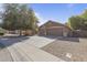 Charming home boasts a three-car garage and a well-maintained front yard with mature trees at 1113 E Devon Dr, Gilbert, AZ 85296