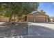 Beautiful home exterior with large front yard, lawn, and three car garage at 1113 E Devon Dr, Gilbert, AZ 85296