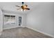 Cozy bedroom with wooden floors, ceiling fan, and window views at 1166 E Del Rio St, Chandler, AZ 85225