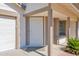 Close up of front door featuring a storm door and security screen with a small green bush at 1166 E Del Rio St, Chandler, AZ 85225