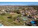 Wide aerial of the community with a park and lake in the foreground at 1233 E Azure Sea Ln, Gilbert, AZ 85234