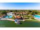 A tranquil aerial view showcases a resort-style community with a pool and artificial beach at 1233 E Azure Sea Ln, Gilbert, AZ 85234