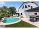 A resort-style pool and backyard with a patio kitchen offer the perfect outdoor lifestyle experience with room for entertaining at 1233 E Azure Sea Ln, Gilbert, AZ 85234