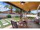 Covered outdoor patio featuring multiple ceiling fans, a seating area and a unique grid-style grass at 1233 E Azure Sea Ln, Gilbert, AZ 85234