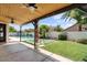 Inviting backyard showcasing a pool, covered patio, green lawn, and stylish concrete paver design for outdoor pleasure at 1233 E Azure Sea Ln, Gilbert, AZ 85234