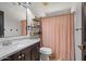 Cozy bathroom featuring a single vanity and a shower with a patterned curtain at 1233 E Azure Sea Ln, Gilbert, AZ 85234