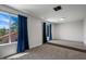 Bright bedroom featuring large windows, plush carpeting, and a raised platform area at 1233 E Azure Sea Ln, Gilbert, AZ 85234