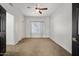 Bedroom with ceiling fan, closet, and large window at 1233 E Azure Sea Ln, Gilbert, AZ 85234