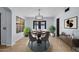 Dining area with a modern light fixture, a round table, and bright light, ideal for hosting at 1233 E Azure Sea Ln, Gilbert, AZ 85234