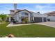 Charming single-story home featuring a tile roof, a three-car garage, and a well-manicured lawn at 1233 E Azure Sea Ln, Gilbert, AZ 85234