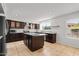 Bright kitchen featuring granite countertops, custom cabinetry, stainless appliances, and ample natural light at 1233 E Azure Sea Ln, Gilbert, AZ 85234