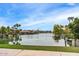 Panoramic lake view showcasing beautiful waterfront homes and palm trees, creating a tranquil living environment at 1233 E Azure Sea Ln, Gilbert, AZ 85234