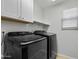 Modern laundry room with white cabinetry and new appliances at 1233 E Azure Sea Ln, Gilbert, AZ 85234