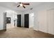 Living room with ceiling fan and entrance to bathroom and kitchen at 1233 E Azure Sea Ln, Gilbert, AZ 85234