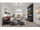 Bright living room features a modern fireplace, an elegant light fixture, and lots of natural light at 1233 E Azure Sea Ln, Gilbert, AZ 85234