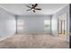 Expansive main bedroom with neutral carpeting, ample natural light, and a ceiling fan at 1233 E Azure Sea Ln, Gilbert, AZ 85234